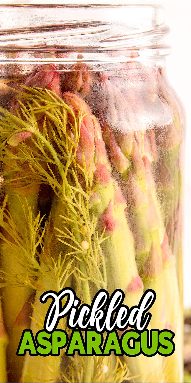 A jar of Pickled Asparagus spears with herbs, labeled "Pickled Asparagus," showcases crisp, tangy vegetables infused with savory flavor.