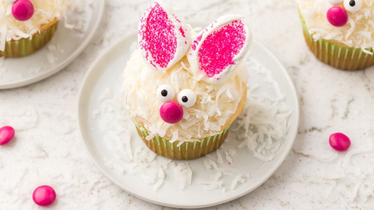 a cupcake with coconut on top, candy eyes, and m&m nose , and a cut marshmallow with pink sanding sugar for ears