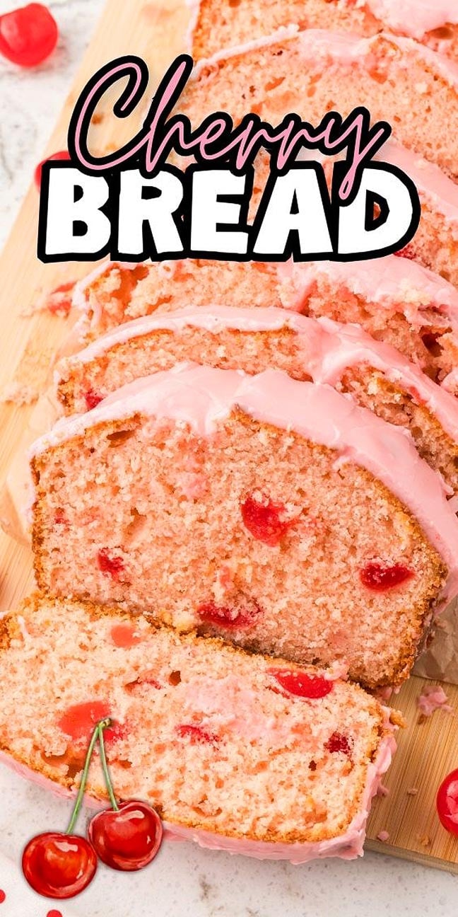 Cherry Bread is sliced with pink icing and visible cherries, beautifully displayed on a wooden board.