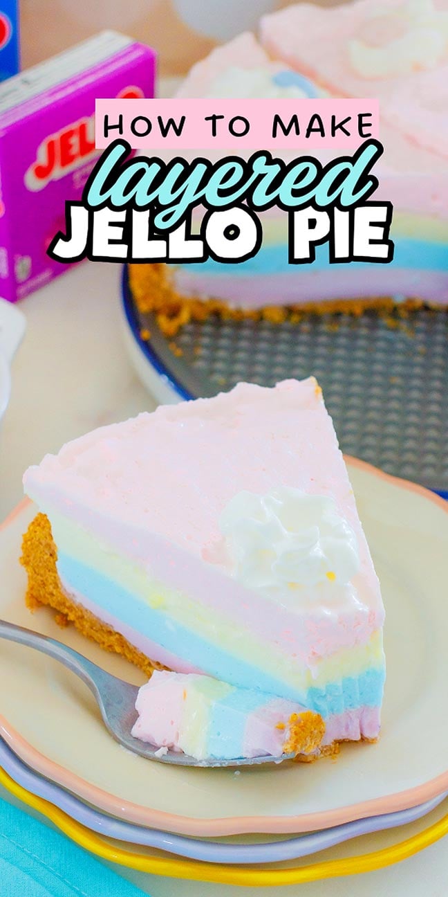 A slice of pastel layered Jello pie with whipped cream sits on a plate, beside the whole Layered Jello Pie and colorful Jello boxes.