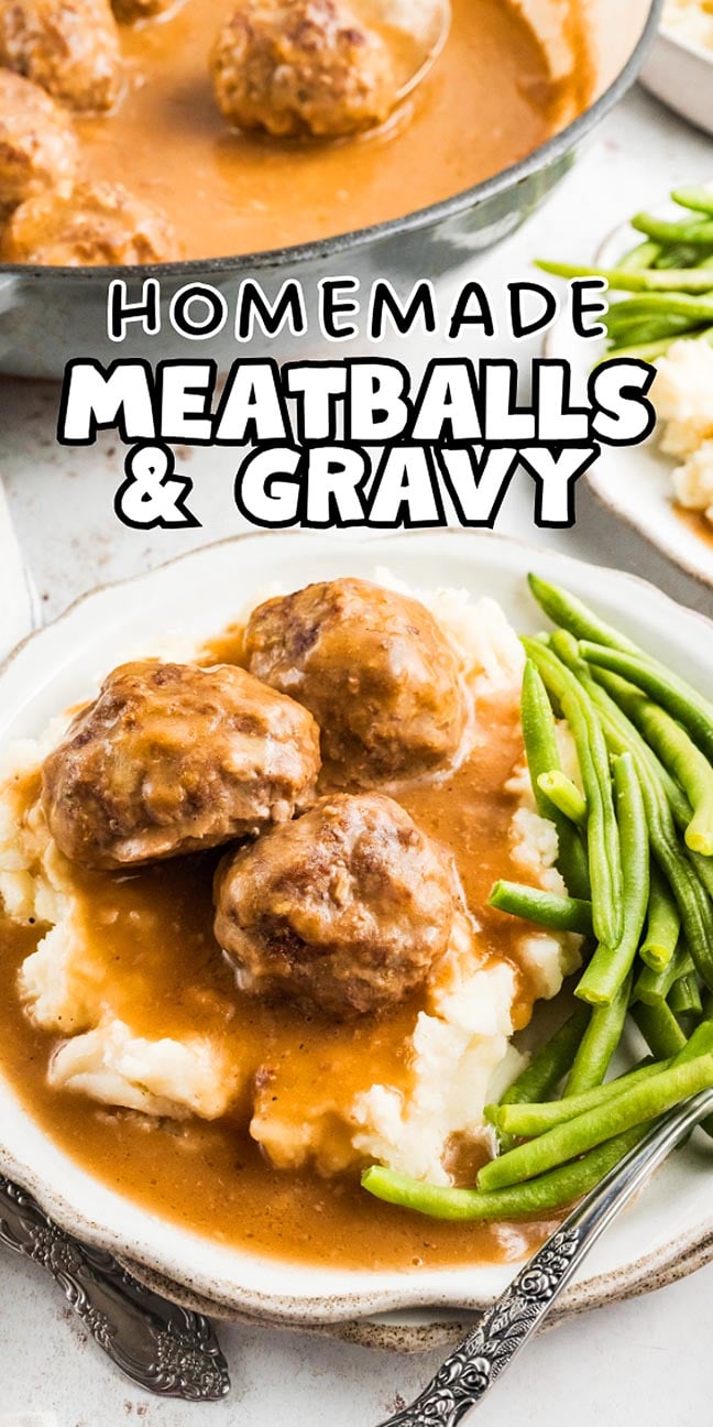 Three meatballs and gravy rest on mashed potatoes, served with green beans on a white plate.