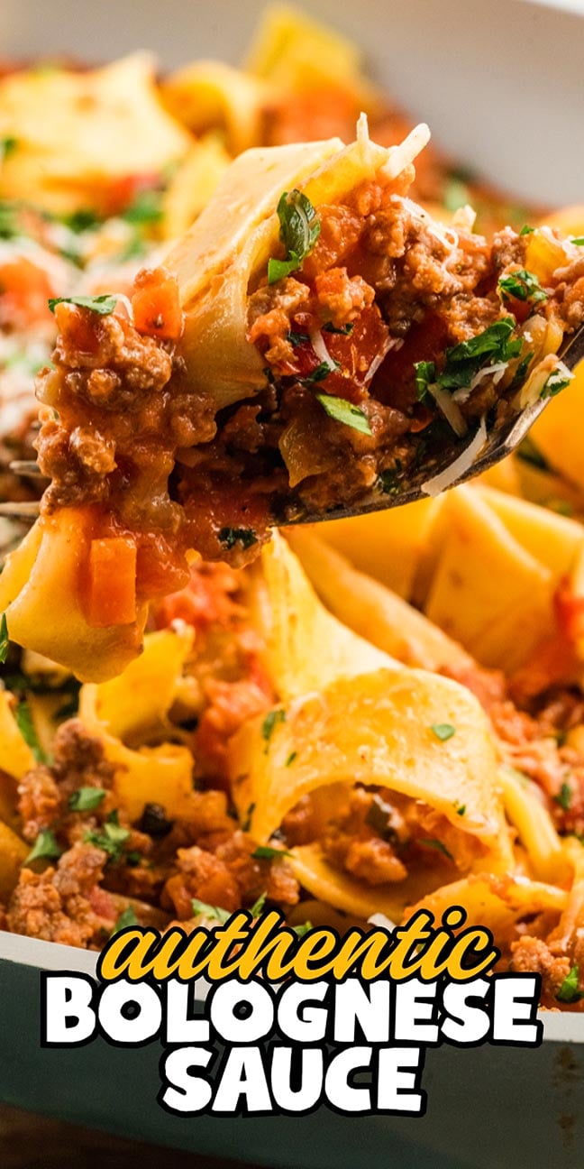 A spoonful of pasta with Authentic Bolognese Sauce, topped with herbs, is held above a dish brimming with more pasta.