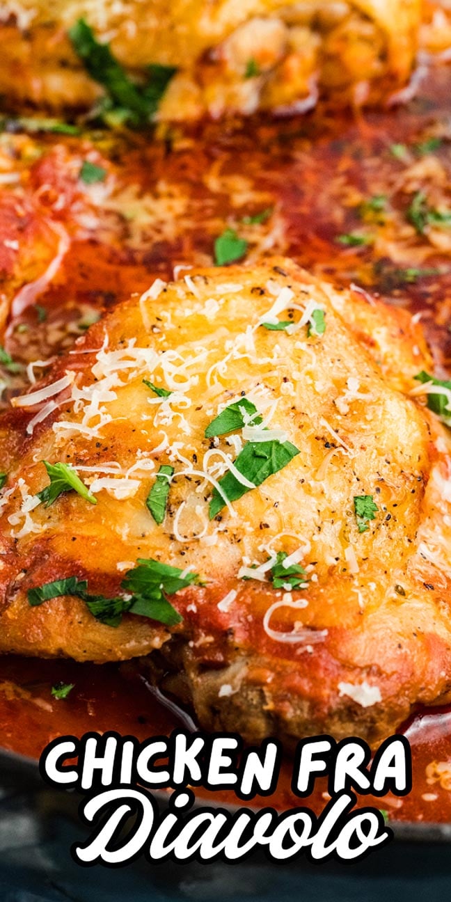Close-up of chicken fra diavolo topped with grated cheese and herbs, served in a spicy tomato sauce for a bold, flavorful dish.