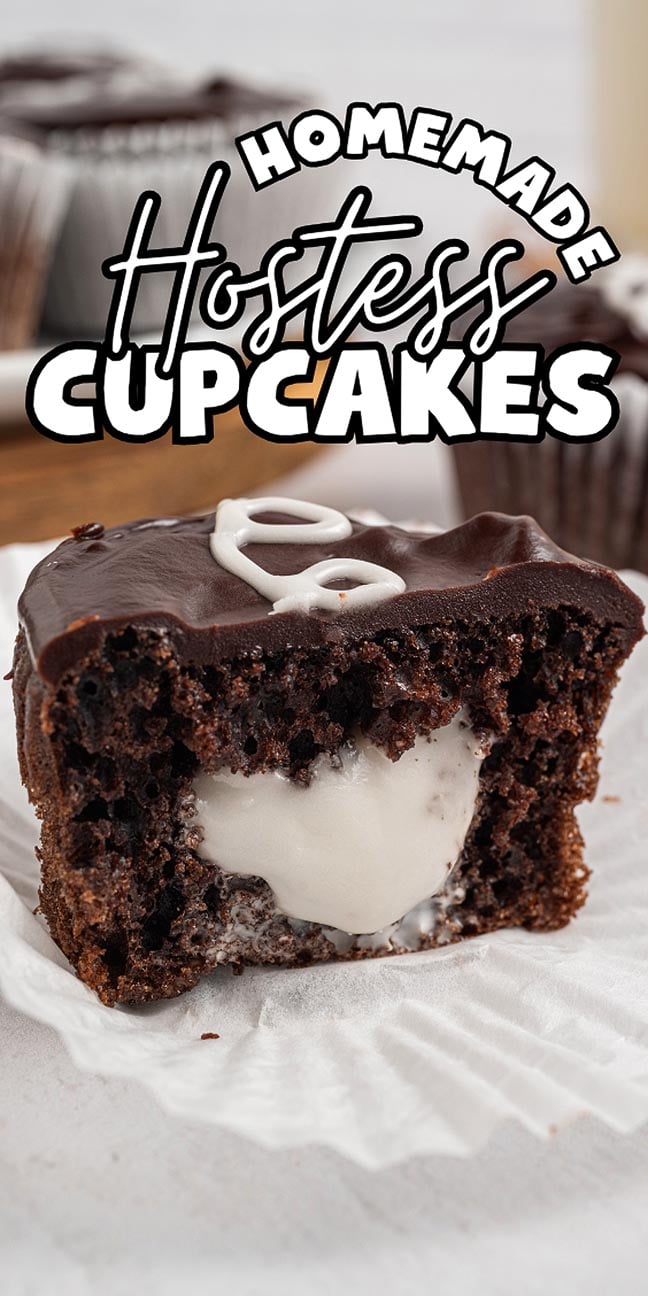 A bitten chocolate cupcake with creamy filling and rich chocolate icing, labeled "Homemade Hostess Cupcakes," captures the nostalgic taste of a classic treat made from scratch.