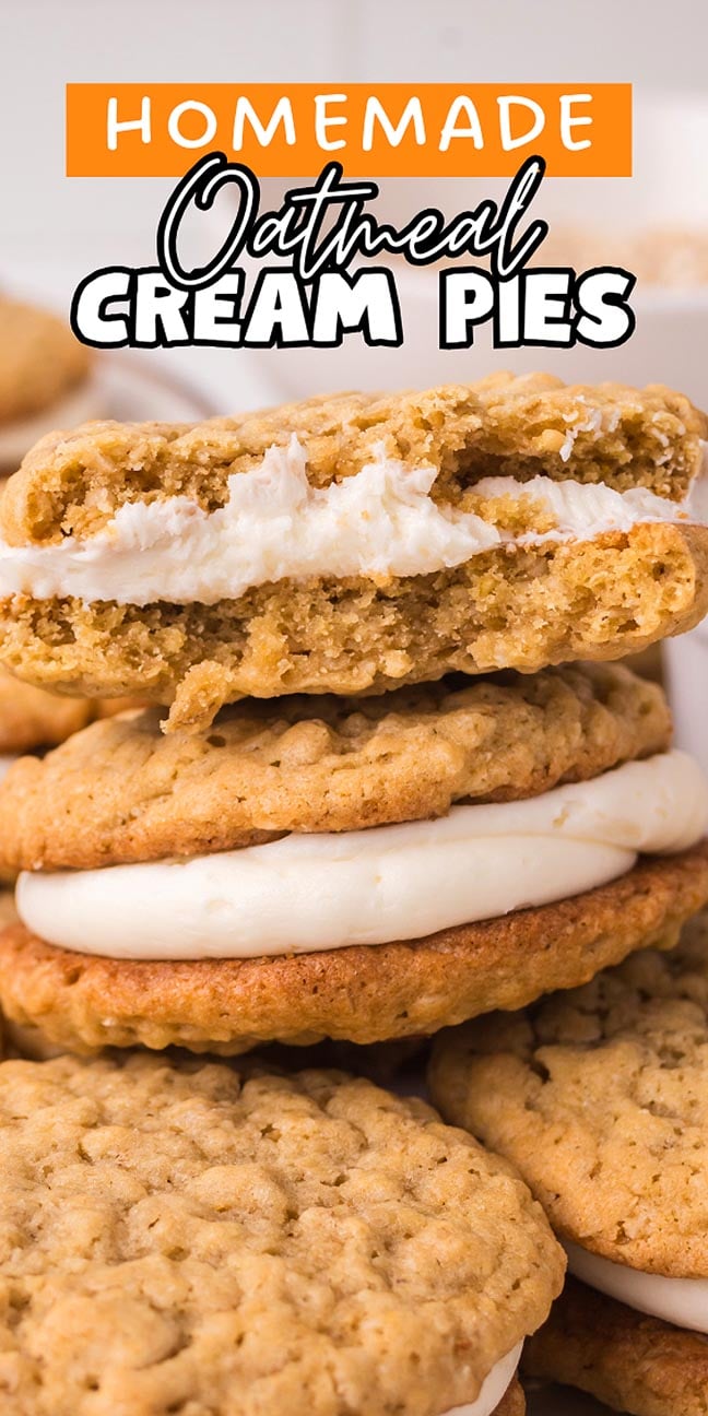 A close-up of Homemade Oatmeal Cream Pies, some stacked and one broken in half to reveal the creamy filling inside.