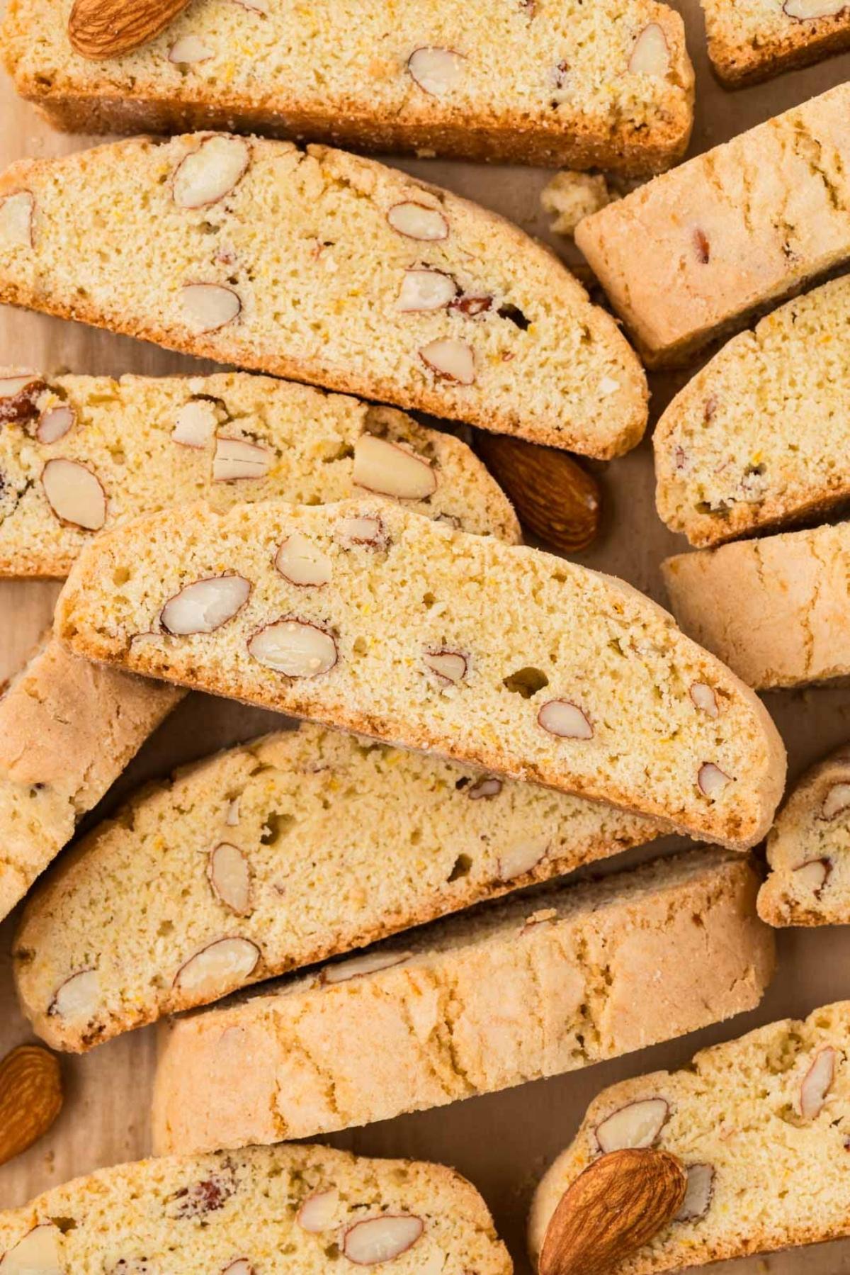 Close-up of almond biscotti stacked together, showing their crunchy texture and visible almond pieces.