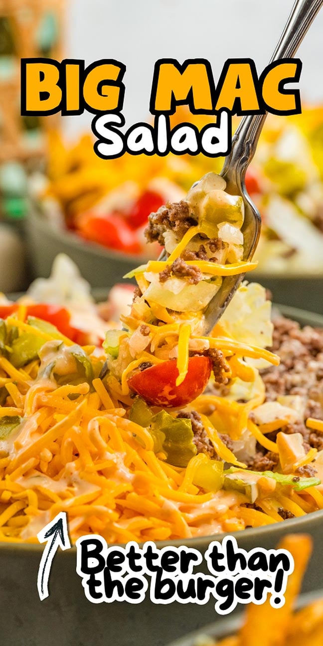 A fork holds up a bite of Big Mac Salad, piled high with cheese, lettuce, ground beef, pickles, and tomato.