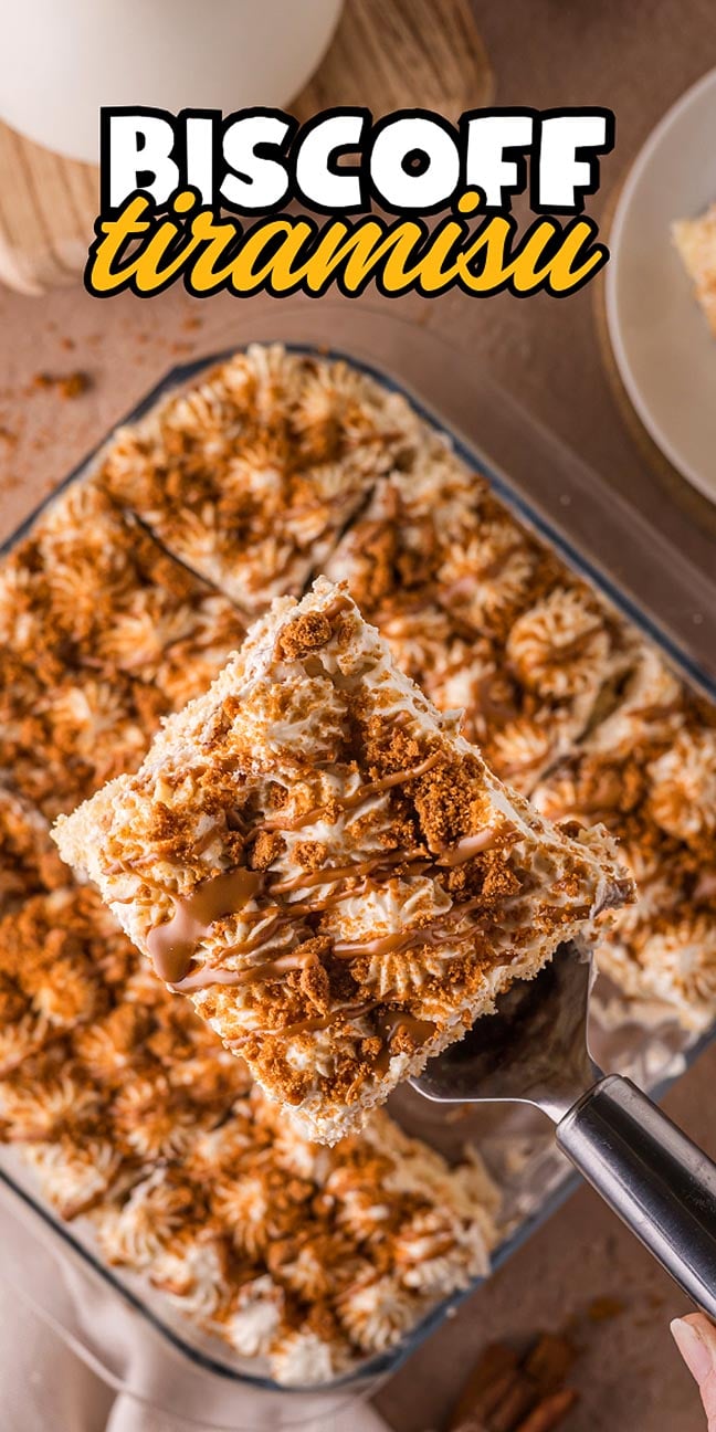 A spatula lifts a square of creamy Biscoff Tiramisu from a tray, topped with luscious cream and cookie crumbs.