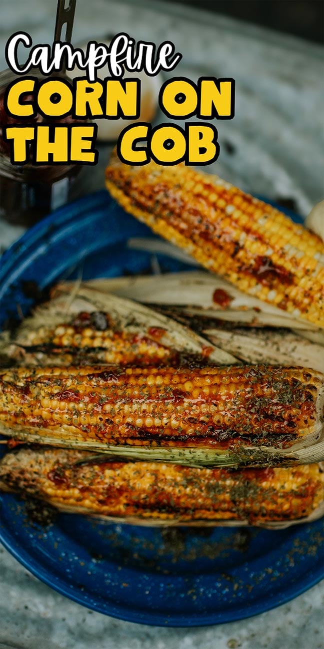 Campfire grilled corn on the cob with seasoning on a blue plate, text reads "Campfire Corn on the Cob.