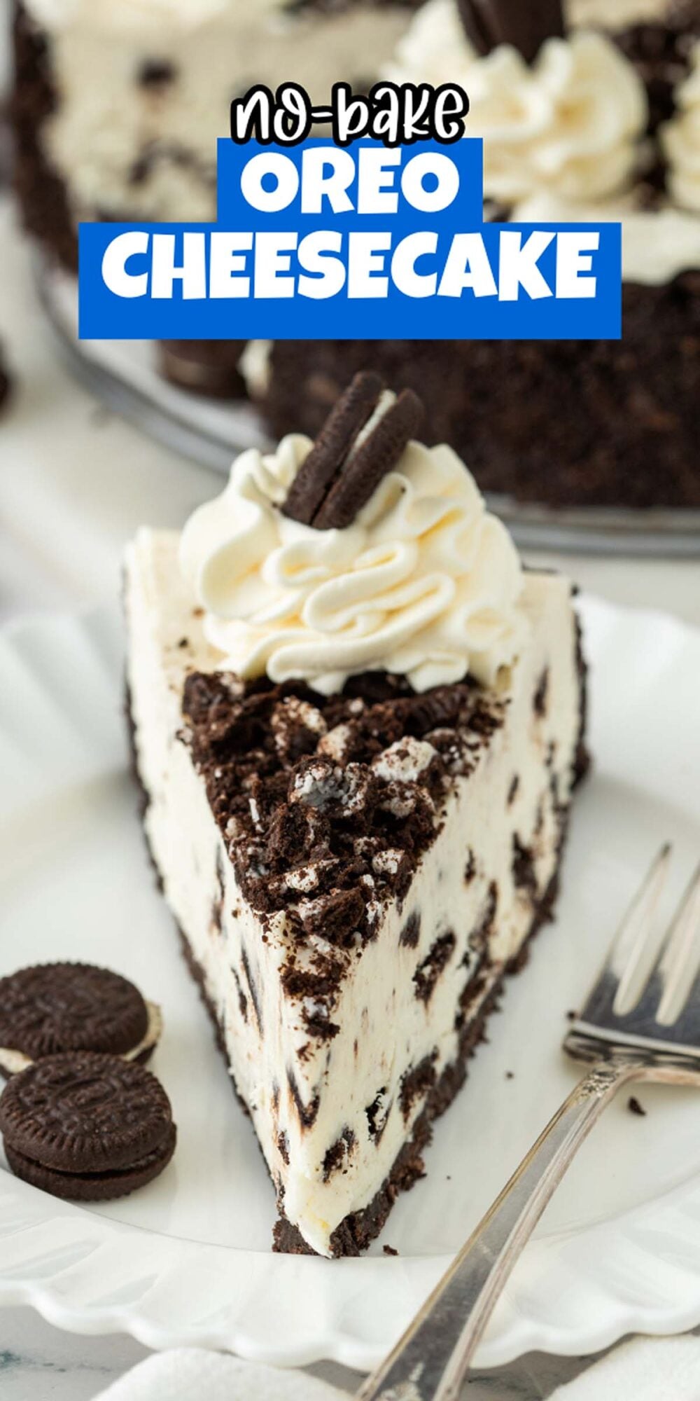 A slice of No Bake Oreo Cheesecake topped with whipped cream and mini Oreos sits on a white plate with a fork, ready to indulge your sweet tooth.