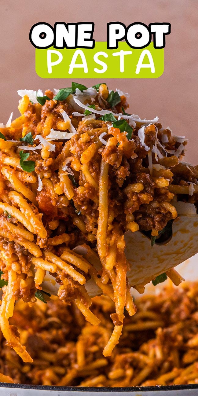 A spoon lifts cheesy, saucy one pot pasta from a pot; text above reads "One Pot Pasta.