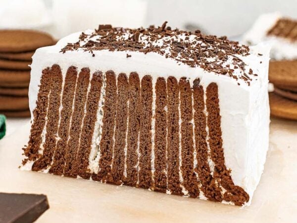 Chocolate Icebox Cake with chocolate cookies and whipped cream, sliced to show the deliciously layered interior of this classic Chocolate Icebox Cake dessert.