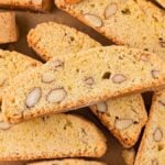 Almond Biscotti cookies arranged on parchment paper, displaying their crunchy texture and whole almonds inside.