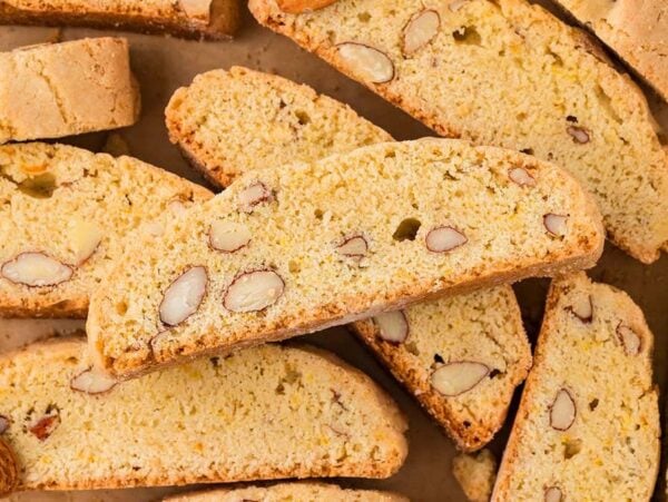 Almond Biscotti cookies arranged on parchment paper, displaying their crunchy texture and whole almonds inside.