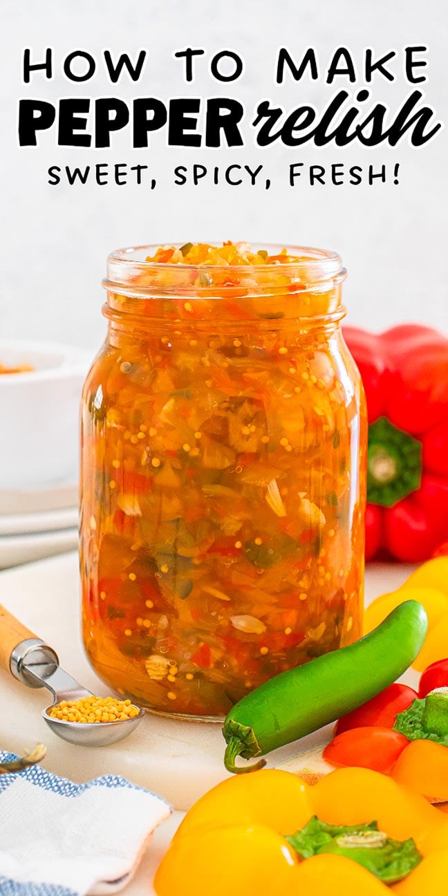 A jar of colorful pepper relish surrounded by fresh peppers and mustard seeds on a table.
