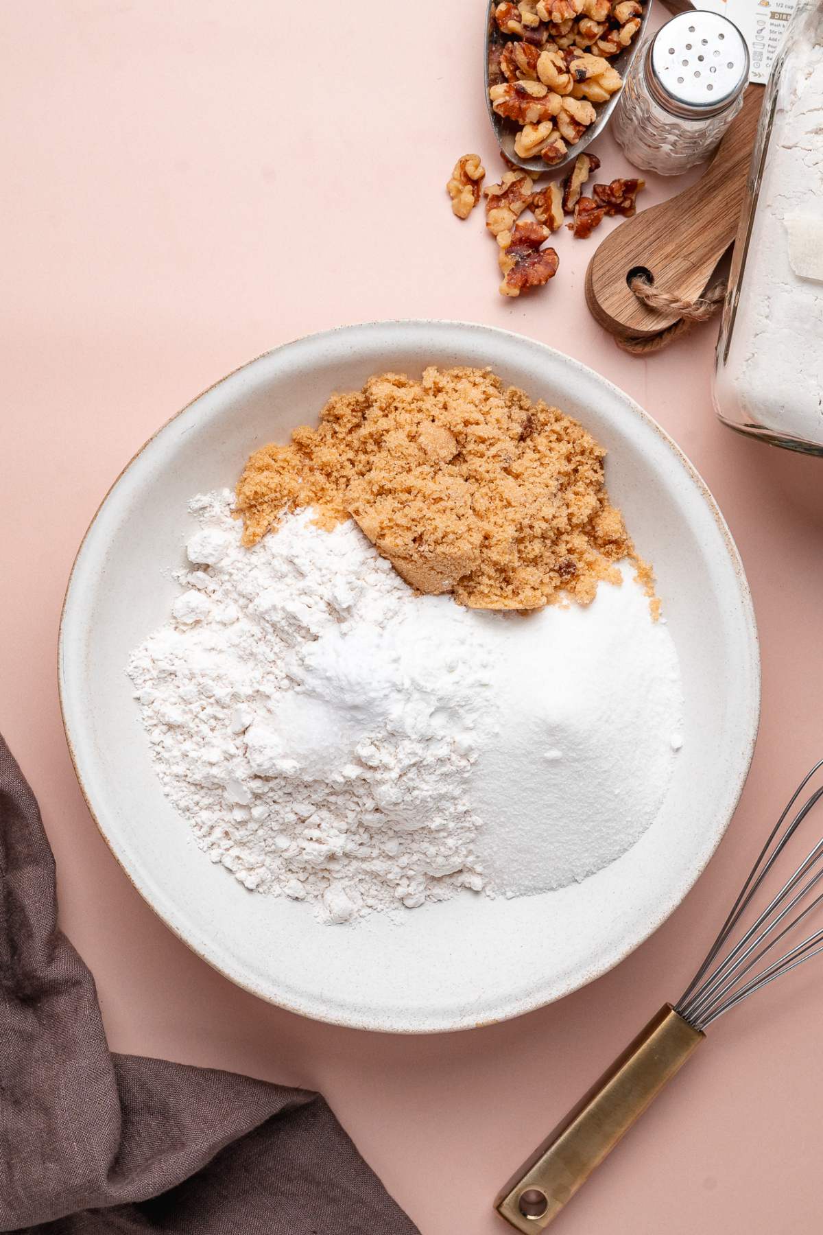 A plate with brown sugar, flour, and white sugar.