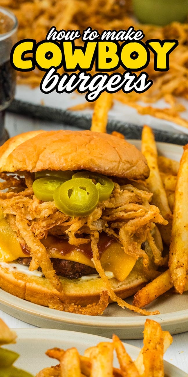A delicious cowboy burger topped with crispy fried onions, melted cheddar cheese, spicy jalapeños, and served with fries on the side. Text reads “how to make cowboy burgers.”.