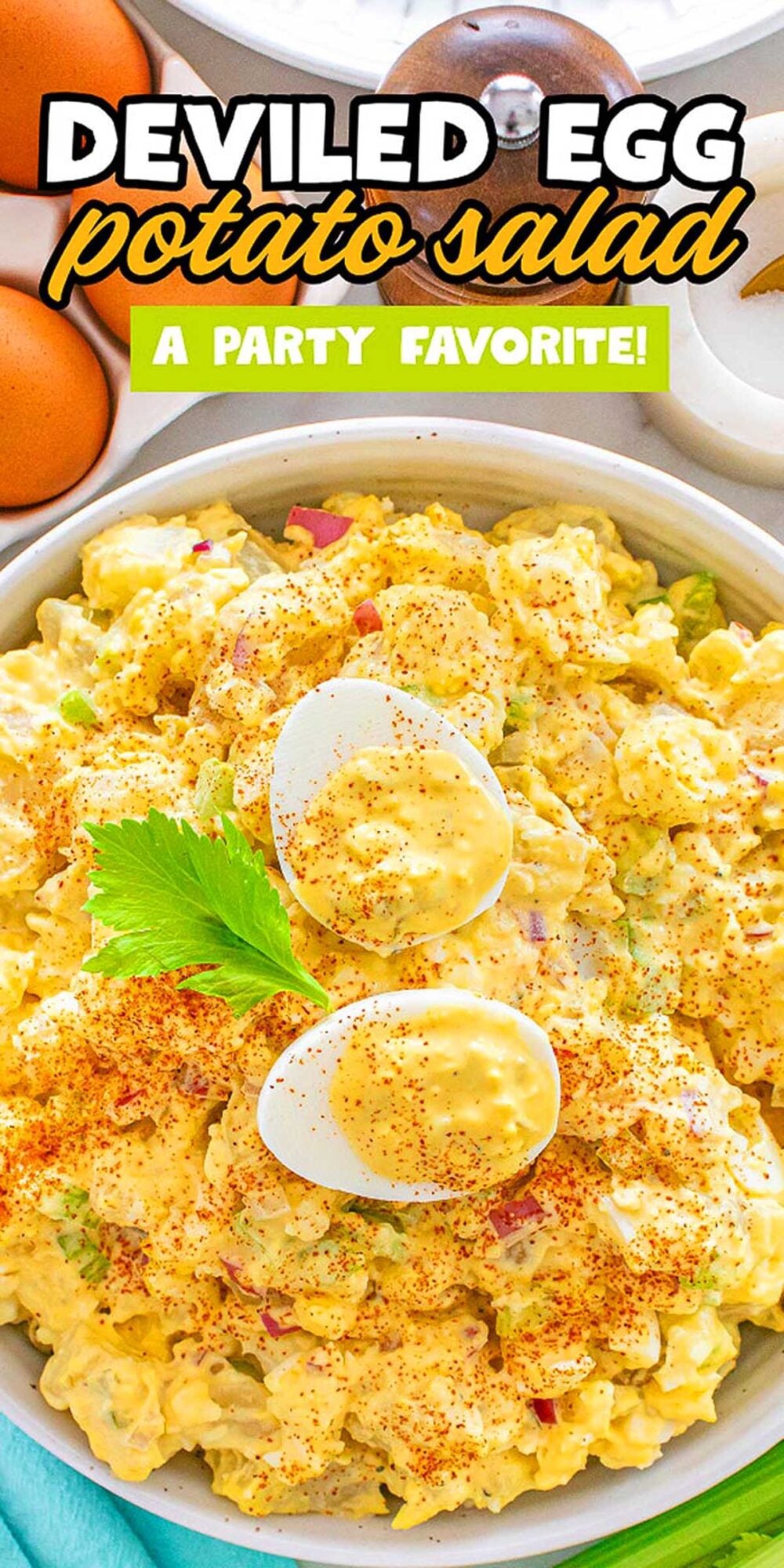 Bowl of deviled egg potato salad topped with sliced eggs, paprika, and a sprig of parsley.