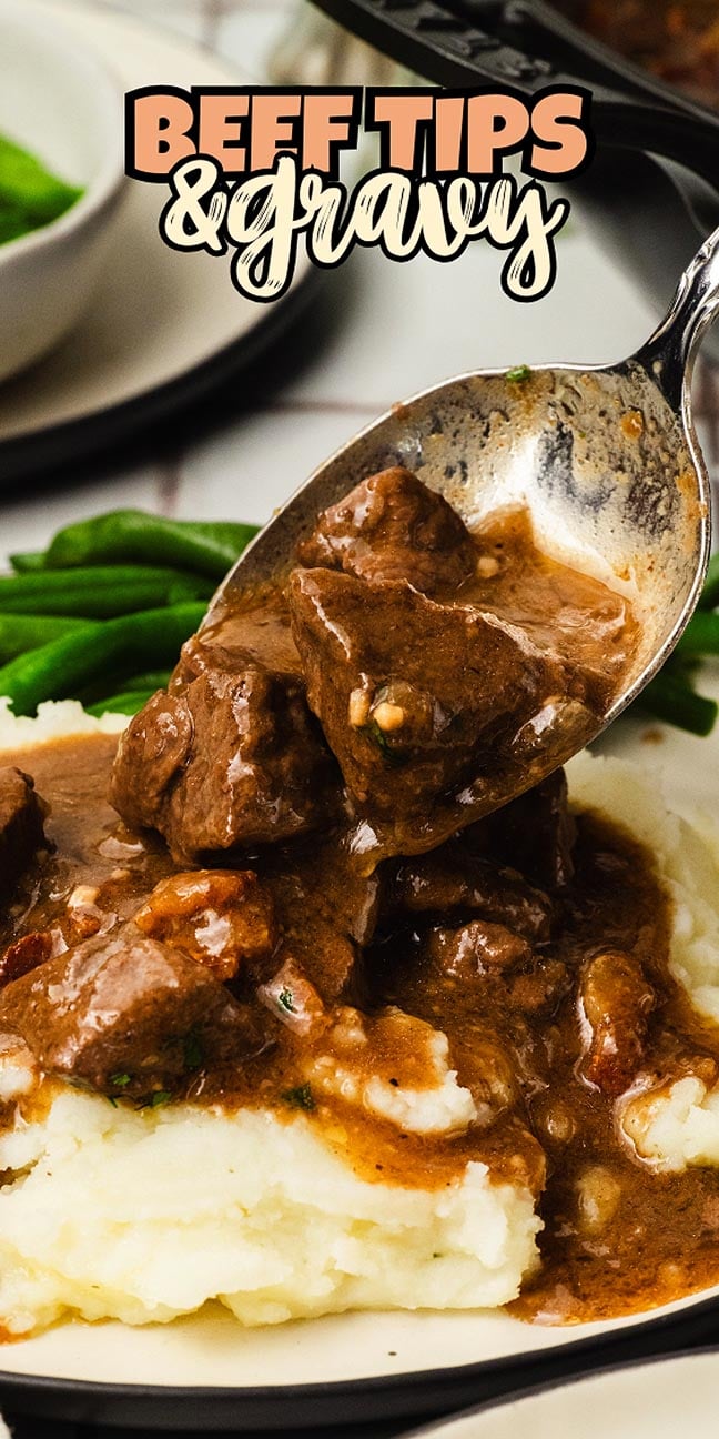 Beef tips with rich brown gravy served over mashed potatoes, with green beans on the side.