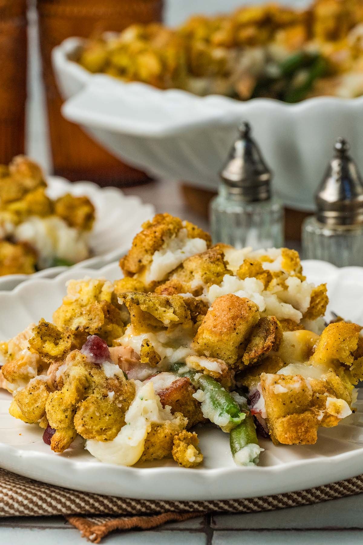 A serving of leftover thanksgiving casserole on a white plate.